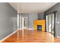 Bright living room showcasing hardwood floors and a fireplace at 8055 W Eastman Pl # 104, Lakewood, CO 80227