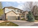 Beautiful two-story home with stone accents, a three-car garage, and well-maintained landscaping at 10260 Longview Dr, Lone Tree, CO 80124