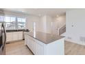 A gourmet kitchen featuring quartz countertops, a large island, and modern appliances at 712 N Bently St, Watkins, CO 80137