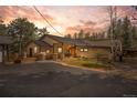 Charming single-story home featuring a beautiful yard, covered porch, and convenient circular driveway at 32173 Soda Creek Dr, Evergreen, CO 80439
