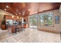 Bright kitchen featuring a central island, stainless steel appliances, and access to outdoor deck at 32173 Soda Creek Dr, Evergreen, CO 80439