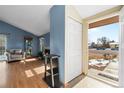 Cozy living room with vaulted ceilings, a fireplace, hardwood floors, and an open view to the entryway at 3545 W 132Nd Pl, Broomfield, CO 80020