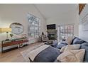 Bright living room featuring a fireplace, large windows, and comfortable seating area at 1080 E 130Th Ave # A, Thornton, CO 80241