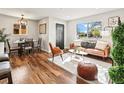Bright living room with a comfortable seating area, dining space, and a large window for natural light at 3210 Newport St, Denver, CO 80207