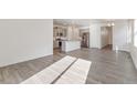 Open floor plan with island and granite countertops connecting the kitchen and living area at 18009 Dandy Brush Ln, Parker, CO 80134