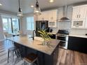 Modern kitchen boasts an island with seating, stainless steel appliances, and stylish pendant lighting at 1732 Stable View Dr, Castle Pines, CO 80108