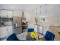 Eat-in kitchen featuring stainless steel appliances and white cabinetry at 11510 Otis St, Westminster, CO 80020
