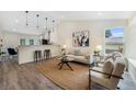 Bright living room with modern lighting, stylish decor, and hardwood floors at 11510 Otis St, Westminster, CO 80020