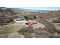 Aerial view of the property featuring a grey home and red barn on an expansive, natural hillside lot at 2485 5Th St, Castle Rock, CO 80104