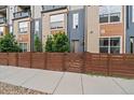Townhome featuring a private fenced-in yard and modern facade at 3522 W 17Th Ave, Denver, CO 80204