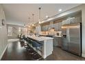 Modern kitchen featuring stainless steel appliances and a large island with bar seating at 3522 W 17Th Ave, Denver, CO 80204