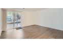 A bright living room features wood-look floors and a glass sliding door to a patio area at 5300 E Cherry Creek South Dr # 217, Denver, CO 80246