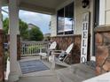 Inviting front porch with comfortable seating, perfect for relaxing and enjoying the outdoors at 12196 Helena St, Commerce City, CO 80603