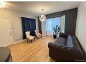 Cozy living room featuring hardwood floors, stylish furniture, and ample natural light at 12196 Helena St, Commerce City, CO 80603