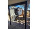 Elevated backyard playhouse, accessible by stairs, offering a fun outdoor space for children to enjoy at 1051 Jasper St, Aurora, CO 80011