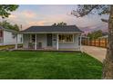 Charming home features a well-maintained front yard, covered porch, and carport at 7752 Meade St, Westminster, CO 80030