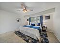 Comfortable bedroom with a ceiling fan, large window and blue accents at 8364 Allison Ct, Arvada, CO 80005