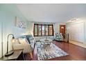 Cozy living room featuring a large bay window and hardwood floors at 8364 Allison Ct, Arvada, CO 80005