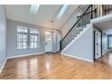 Bright and airy living room featuring hardwood floors, a staircase with black railings, and skylights at 9902 Independence St, Broomfield, CO 80021