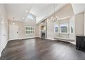 Bright living room with hardwood floors, a fireplace and an elegant chandelier at 3745 Balderas St, Brighton, CO 80601