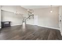 Open-concept living room with hardwood floors and staircase at 3745 Balderas St, Brighton, CO 80601