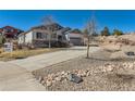 Lovely two-story home featuring a long driveway and beautiful landscaping along the front at 3309 Thornwood Ct, Castle Rock, CO 80108