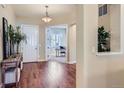 Inviting foyer with gleaming hardwood floors and view to the office space at 3309 Thornwood Ct, Castle Rock, CO 80108