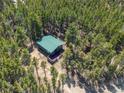 Aerial view of a cozy cabin on a wooded lot at 28 Deer Rd, Evergreen, CO 80439