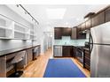Contemporary kitchen with stainless steel appliances, a built-in desk, and a well-lit design at 3059 Curtis St, Denver, CO 80205