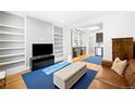 Open-concept living room with built-in shelving, modern furnishings, and a seamless flow to the kitchen at 3059 Curtis St, Denver, CO 80205