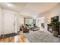 Bright open living area with fireplace and hardwood floors at 6132 Terry Ct, Arvada, CO 80403