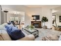 Cozy living room featuring a fireplace and neutral decor at 6132 Terry Ct, Arvada, CO 80403