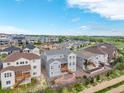 A serene aerial view showcases the backyard of the gray home, complemented by a well-developed surrounding neighborhood at 12953 Bridge View Ln, Parker, CO 80134