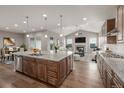 Open-concept kitchen with granite countertops, stainless steel appliances, and a center island with seating at 12953 Bridge View Ln, Parker, CO 80134