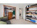 Spacious bedroom offering closet space and rustic open shelving at 902 Pacific Pl, Fort Lupton, CO 80621