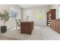 Comfortable office with natural light, built-in bookshelves, and a wooden executive desk at 6000 W Floyd Ave # 116, Denver, CO 80227