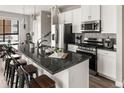 Open kitchen featuring granite countertops, stainless steel appliances and decorative pendant lighting at 1990 S Holly St # 3, Denver, CO 80222