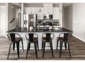 Modern kitchen with stainless steel appliances, granite counters and stylish bar stool seating at 1990 S Holly St # 3, Denver, CO 80222