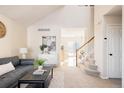 Bright living room with a view into the kitchen and stairs at 5604 S Yakima Way, Aurora, CO 80015