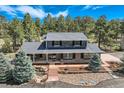 Beautiful aerial view of house, showing a well-manicured lawn, mature trees, and tasteful landscaping at 12454 Antelope Trl, Parker, CO 80138
