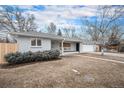 Charming one-story home with a well-manicured lawn, a two car garage, and mature trees at 2455 E Yale Ave, Denver, CO 80210