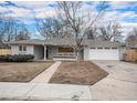 Charming one-story brick home with a well-manicured lawn and attached two car garage at 2455 E Yale Ave, Denver, CO 80210