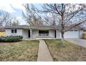 Charming single-story home with a well-maintained front yard, a tidy walkway, and an attached garage at 2455 E Yale Ave, Denver, CO 80210