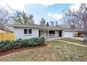 Charming single-story home with a well-maintained lawn and an inviting walkway to the front door at 2455 E Yale Ave, Denver, CO 80210