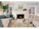 Bright living room features a cozy fireplace, large windows, comfortable seating, and stylish decor at 1944 Hudson St, Denver, CO 80220