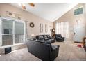 Bright living room with high ceilings, large windows, and comfortable black leather furniture at 2782 S Ceylon St, Aurora, CO 80013