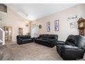 Spacious living area with vaulted ceilings, neutral color palette, and carpeted flooring at 2782 S Ceylon St, Aurora, CO 80013