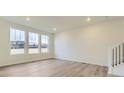 Bright living room with hardwood floors and large windows offering plenty of natural light at 11030 Snowdon St, Parker, CO 80134