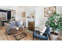 Inviting living room with a decorative fireplace, stylish furniture, and hardwood floors at 1853 W 41St Ave, Denver, CO 80211