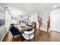 Open concept dining room features hardwood floors and access to the staircase at 1027 Koss St, Erie, CO 80516